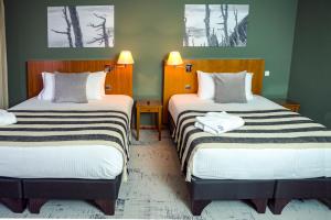 Postel nebo postele na pokoji v ubytování Park Lake Luxury Hotel