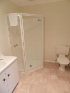 a bathroom with a shower and a toilet at TRC Hotel in Launceston