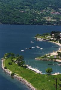 a group of boats docked in a body of water at Green Chalet Scalotta - Wonderful Terrace Lake and Mounts View in Dervio