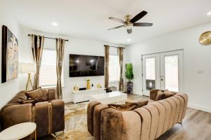 a living room with a couch and a ceiling fan at Chic and Spacious West Dallas Home Near Downtown! in Dallas