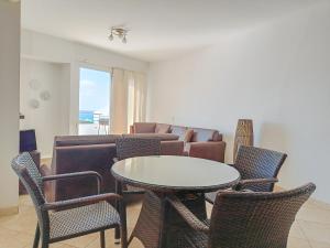 a living room with a couch and a table and chairs at Panoramic View to the ocean Manta in Manta