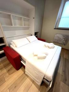 Un dormitorio con una gran cama blanca y una ventana en Home Donatella en Cormano