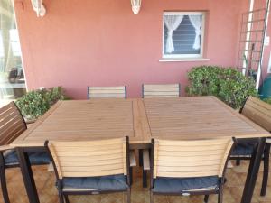 een houten tafel en stoelen in een kamer bij Espectacular terraza y vistas en 1a línea de playa in Cullera