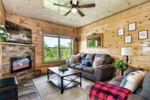 a living room with a couch and a fireplace at Modern Pool Cabin, Hot Tub, Pet Friendly, Secluded, Mins to Wilderness in Sevierville