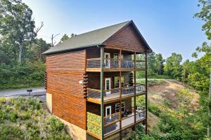 a tree house with balconies on a hill at Modern Pool Cabin, Hot Tub, Pet Friendly, Secluded, Mins to Wilderness in Sevierville