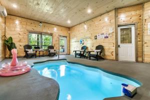 uma piscina num quarto com paredes de madeira em Modern Pool Cabin, Hot Tub, Pet Friendly, Secluded, Mins to Wilderness em Sevierville