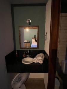 a bathroom with a sink and a mirror at Villaggio Zamprogno in Santa Teresa