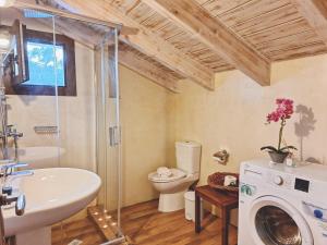 a bathroom with a sink and a washing machine at Alegria apartments in Gaios +62 photos