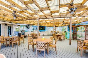 a restaurant with tables and chairs on a deck at HH Beach & Tennis 322B in Hilton Head Island