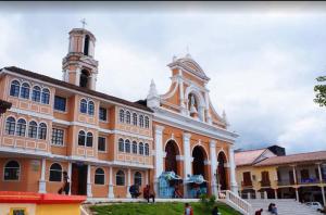 a large building with a tower on top of it at JOMALEY , Real HOTEL Jomaley in Loja