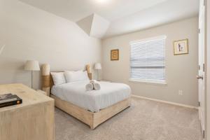 a bedroom with a bed and a window at Brand New Lake Travis by Barcle in Leander
