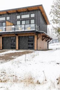 a house with snow on the ground in front of it at 22 Sunniva by FantasticStay in Fernie