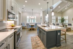 a kitchen and living room with a table and chairs at Naples Retreat with Community Perks 6 Mi to Beach! in Naples