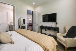 a bedroom with a bed and a tv and a chair at Naples Retreat with Community Perks 6 Mi to Beach! in Naples