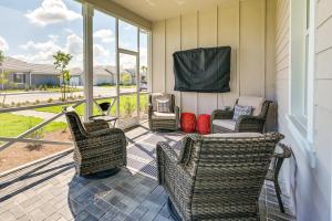 a porch with chairs and a couch and windows at Naples Retreat with Community Perks 6 Mi to Beach! in Naples