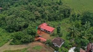 an overhead view of a house with a red roof at Cabo De Rama Cottage in Cola