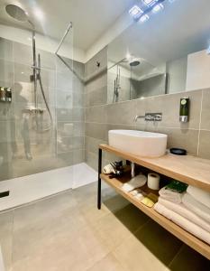 W łazience znajduje się umywalka i prysznic. w obiekcie Malvezzi24 Boutique Rooms w mieście Desenzano del Garda