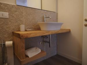 a bathroom with a sink on a wooden counter at Alloggio turistico Corte Grisi in Badia Calavena