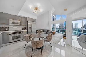 a kitchen and living room with a table and chairs at Sunbeam Plush 2 Story Loft in Miami