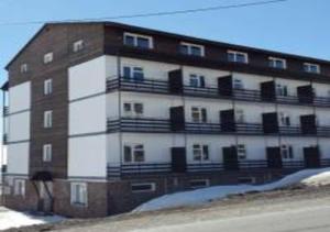 a large building with balconies on the side of it at Marina Apartments in Gudauri