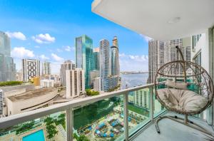 a chair on a balcony with a view of the city at Sunbeam Plush 2 Story Loft in Miami