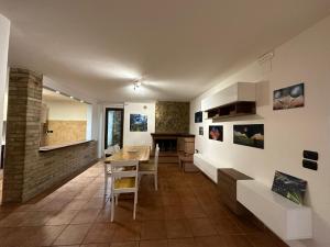 a kitchen and dining room with a table and chairs at House gallery in Perugia