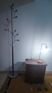 a desk with a lamp and a tree in a room at Private Bedroom Paphos Central in Paphos City