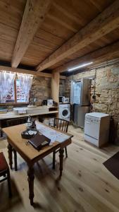 a kitchen with a wooden table and a kitchen with a stove at Wohnen im Denkmal. Erholung pur. in Sulz am Neckar
