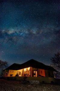 a house under a night sky with stars at Yingwe self catering villa bordering Kruger with private pool in Phalaborwa