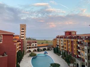 a view of a pool in a courtyard with buildings at Art studio Marina Cape-private host in Ravda