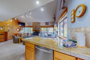 a kitchen with a counter top and a living room at Pine Ridge 05E in Breckenridge