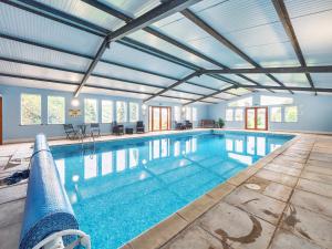 a large swimming pool with a ceiling at Old Rectory Cottages in Aberhafesp