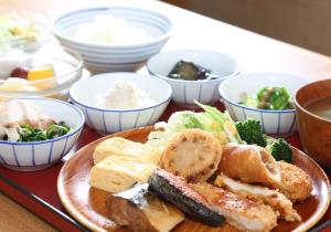 a plate of food on a table with bowls of food at Daiwa Roynet Hotel Kobe Sannomiya in Kobe +33 photos