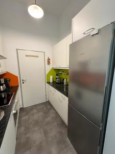 a kitchen with a stainless steel refrigerator in it at Vienna Apartment Gutarra II in Vienna