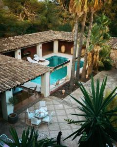 an aerial view of a house with a swimming pool at Casa Balandra: Experiential Guesthouse in Pòrtol