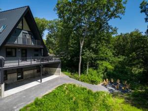 a house with a bunch of birds on the side of it at Emberwood Lodge - Luxury Cabin, Kid Friendly in Catskill