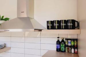 a kitchen with a shelf with bottles on it at Emberwood Lodge - Luxury Cabin, Kid Friendly in Catskill +34 photos