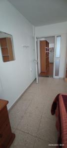 een kamer met een witte muur en een kamer met een tafel bij Private Bedroom Paphos Central in Paphos City