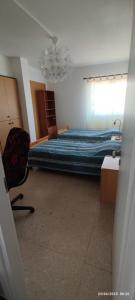 a bedroom with a bed and a chair in it at Private Bedroom Paphos Central in Paphos City