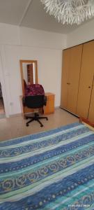 an empty room with a chair and a large rug at Private Bedroom Paphos Central in Paphos City