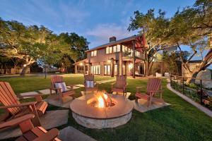 a fire pit in the yard of a house at AustinTeton's Sunset Cliff Resort on Lake Travis - PRIVATE WEDDING, EVENT, HEATED POOL, BOAT DOCK in Austin