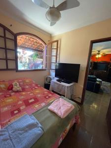 a bedroom with a bed and a flat screen tv at Casa Lazer&Tranquilidade @lazer.tranquilidade in Brumadinho