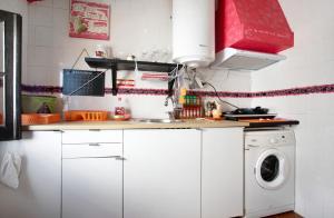 a white kitchen with a washing machine in it at Love Temple in Ericeira
