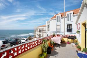 a balcony with a view of the ocean at Love Temple in Ericeira