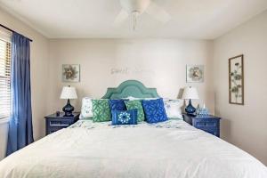 a bedroom with a bed with blue and green pillows at Creekside Gated Golf Mtn Villa w/fast wifi & paved in Franklin