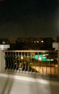 a balcony with a view of a city at night at Two Bedroom Luxury Apartment in New Cairo in Cairo
