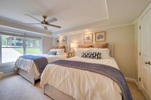 a bedroom with two beds and a window at Milledgeville Home with Private Dock and Dock House! in Milledgeville
