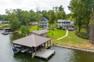 an aerial view of a house on the water with a dock at Milledgeville Home with Private Dock and Dock House! in Milledgeville