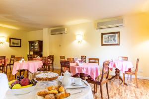 a room with tables and chairs with food on them at Hotel Sant'Andrea in Ravenna