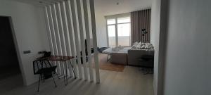 a living room with a couch and a table at Porto Covo Praia Hotel & SPA in Porto Covo